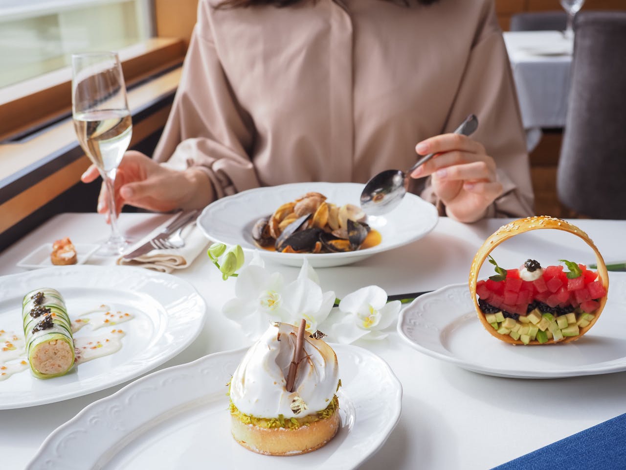An elegant dining setting featuring gourmet dishes and fine dining ambiance, highlighting artful food presentation.